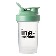 A clear plastic shaker cup with a green lid and the brand 'ine+ nutrition' printed on the front.